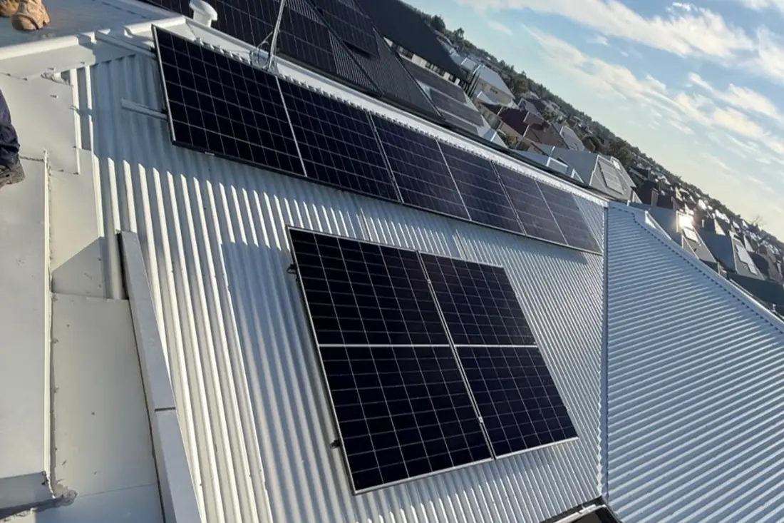 Residential rooftop solar array installed on a metal roof