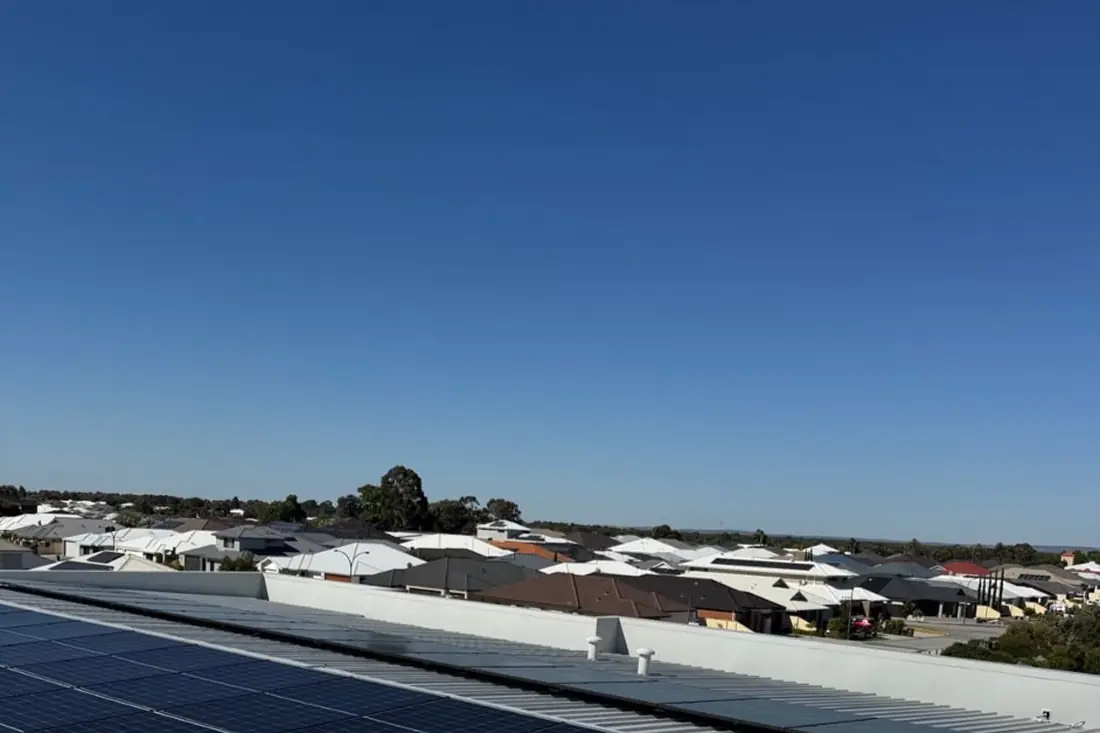 Commercial rooftop solar array on a long metal roof