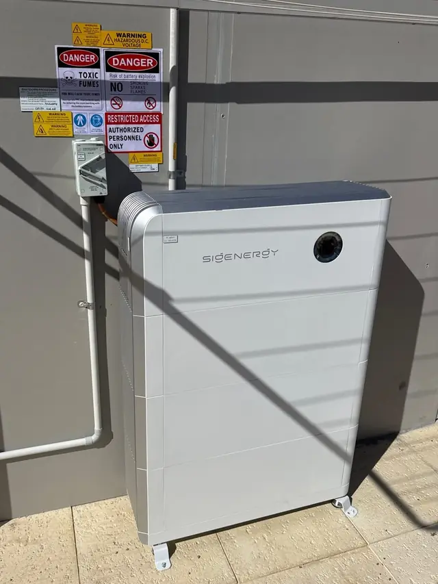 Sigenergy battery system installed against a brick wall