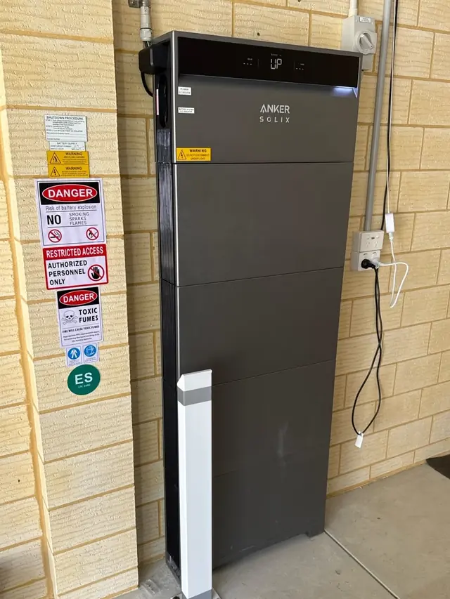 Anker SOLIX home battery installed against a brick wall