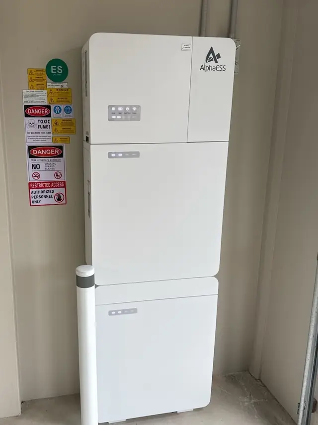 AlphaESS battery system installed against a brick wall